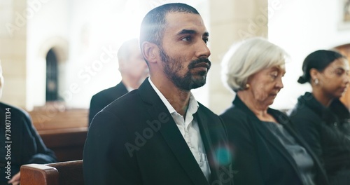 Sad, man and face closeup with depression at a funeral in church for religious service and mourning. Grief, male person and burial with death, ceremony and grieving loss at chapel event in a suit