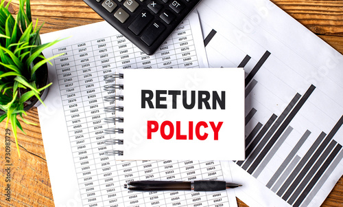 RETURN POLICY text on a notebook with chart and calculator