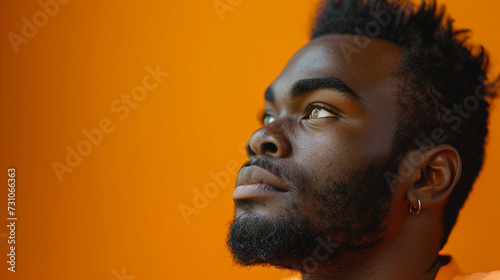 Portrait of an African-American black man, close-up face, critical emotional serious or implausible facial expression, thoughtful or doubtful, prejudiced and reproachful