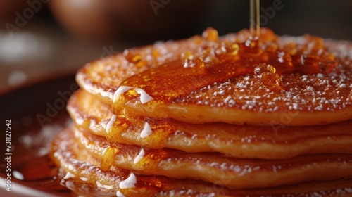 a stack of pancakes on a plate with syrup being drizzled on top of the pancakes and syrup being drizzled on top of the pancakes.