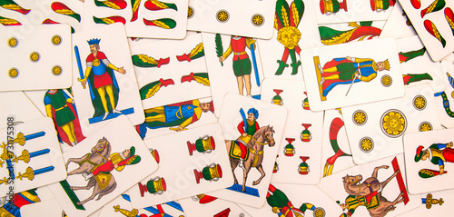Spanish-suited playing cards. The Neapolitan pattern widely used in central and southern Italy. Zenith view on bulk playing cards. Ideal for background or backdrop. Card games.
