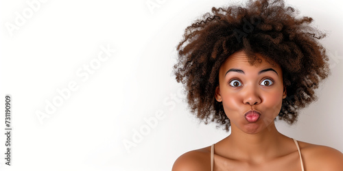 A Black Woman with an Afro is making a Silly Face with a White Background.
