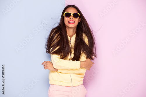 Happy African American woman with long hair wearing sunglasses and smiling
