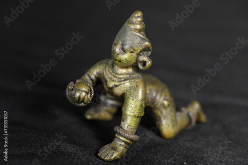 A small brass figure of a child crawling, made long ago in India, enchants and amuses. 