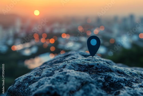 Map pin button on rock over cityscape during sundown pointer concept