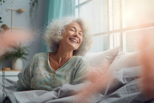 Happy fresh mature middle aged woman stretching in bed waking up alone happy concept, smiling old senior lady awake after healthy sleep sitting in cozy comfortable bedroom interior enjoy good morning.