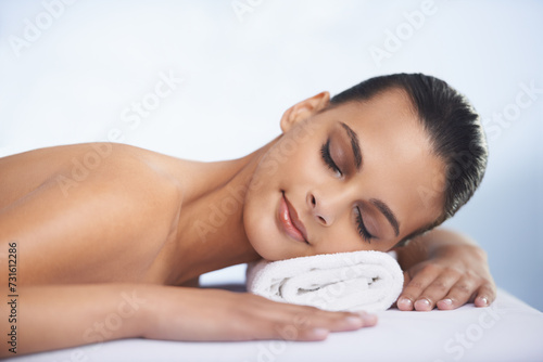 Relax, sleeping and woman at spa with self care, wellness and luxury skin treatment for zen. Calm, cosmetics and young female person with beauty body routine taking nap on towel at health salon.