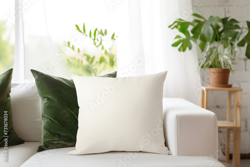 Cozy living room scene with a white square pillow. Blank cushion case template for your graphic design presentation. Pillow cover mock up for print, personalized illustration. Close-up.