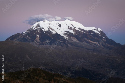 View of snow-capped Illimani mountain with clouds floating above its peak. Bolivia.