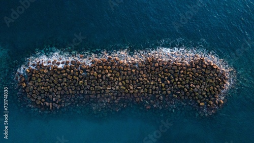 Aerial view of the breakwater in a tranquil blue water