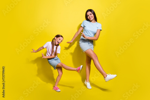 Photo of two energetic girls kids have weekend party dance together isolated over shine color background