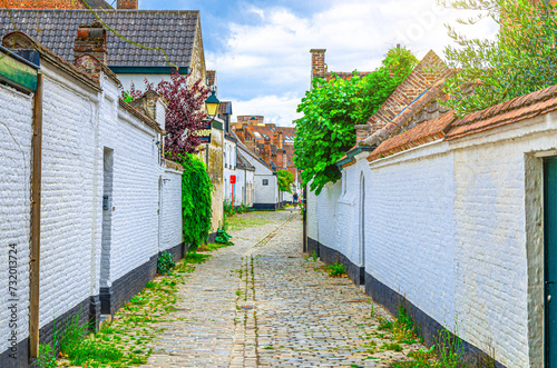 Ludovic Beguinage House Begijnenhuis Ludovicus with white brick walls and narrow street in Beguine city Old St Elizabeth in Ghent city historical center, Gent old town, Belgium