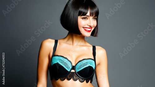 A woman with short black hair and bright red lipstick wears a black and blue bra.