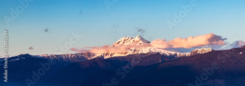 Snow Covered Canadian Rocky Mountain peaks. Sunny Cloudy Sunset