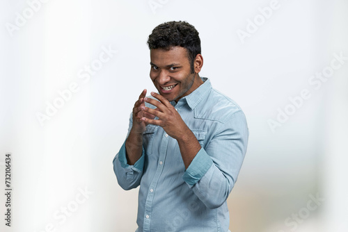 Cunning young man wearing blue shirt thinking about the adventure. Handsome cunning man having a plan.