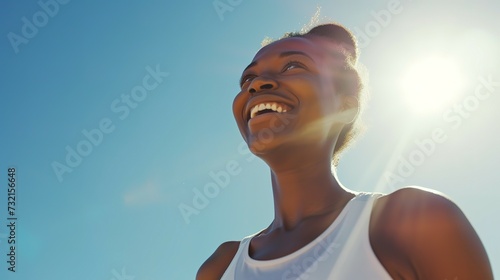 Fitness, black woman and happy athlete smile after running, exercise and marathon training workout. Blue sky, summer sports and run of a African runner breathing with happiness from sport outdoor