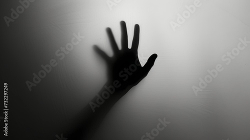 Hand silhouette on grey background. Blurred human hand shape out of focus