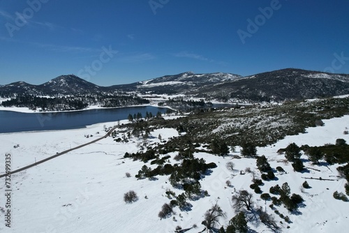 Aerial view of a wintery landscape with snow-capped mountains in Julian,CA