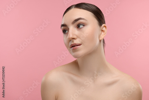 Portrait of beautiful woman on pink background. Space for text