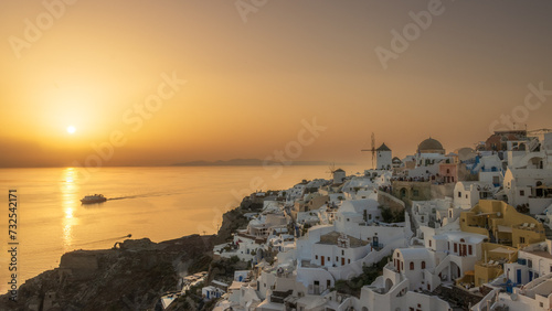A colorful picture of the windmills of Oia in Santorini at sunset