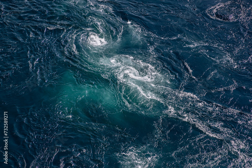 The deep blue of Saltstraumen whirlpool waters is accentuated by the vigorous dance of tidal currents, offering a breathtaking texture and color palette