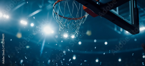 Bottom view of a basketball hoop in an arena under spotlights, preparation for a match, copy space for concept