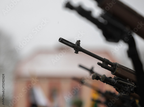 A close-up of the barrel of the m-16 machine gun on a blurred background