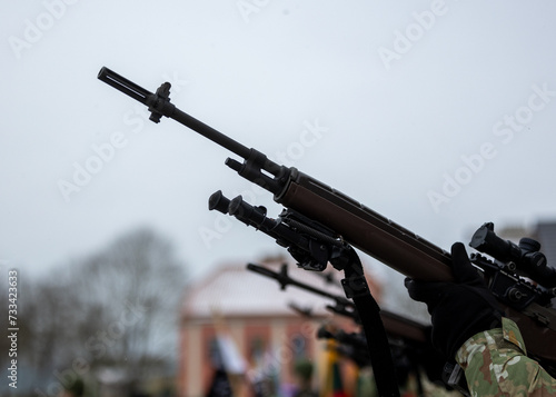 A close-up of the barrel of the m-16 machine gun on a blurred background