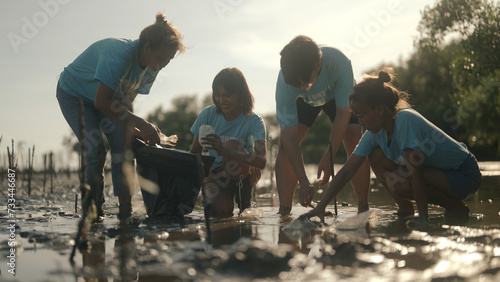 Group of volunteers cleaning on the beach
