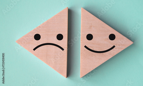 Pessimism and optimism - on wooden triangles on a gray-blue background.