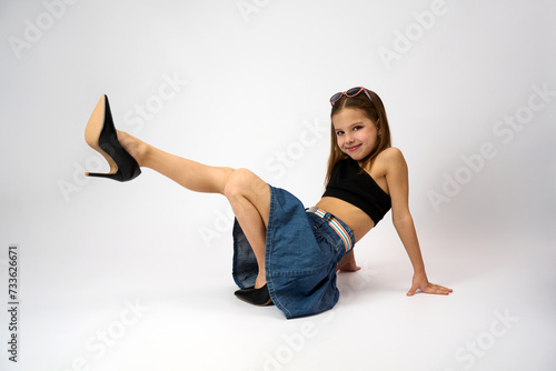 Portrait of a cute girl wearing high heels shoes