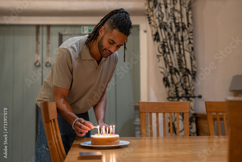Man lighting candles on birthday cake 