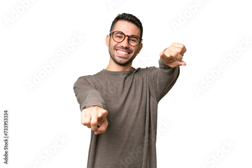 Young handsome caucasian man over isolated background pointing front with happy expression