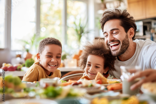 Father shares a joyous moment with his children over a healthy breakfast, reflecting the warmth and happiness of a multicultural family's life