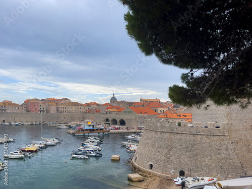 a view of boats in a harbor with a castle in the background