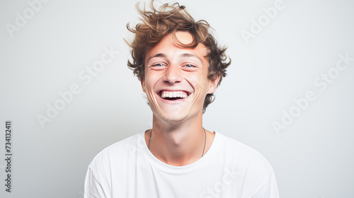 portrait of laughing man with big tooth gap, short hair and freckles,