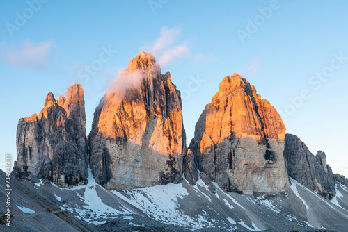 View of Three Peaks of Lavaredo at sunrise in National Park Tre Cime di Lavaredo, Dolomites Alps mountains, Trentino Alto Adige, Sudtirol, Dolomiti, Italy. Summer vacation destination