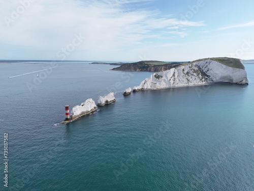 Iconic view of The Needles lighthouse Isle of Wight calm day blue sky drone , aerial .