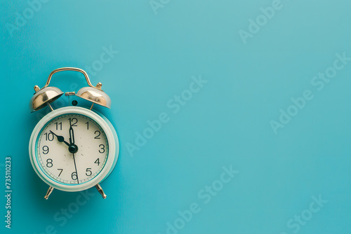 alarm clock on isolated blue background 