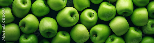 Green Apples Piled Together in Full Frame with a Lush Background