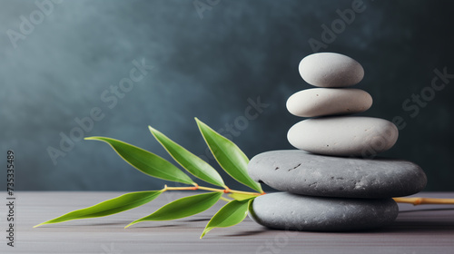zen basalt stones and green bamboo on grey background, spa concept