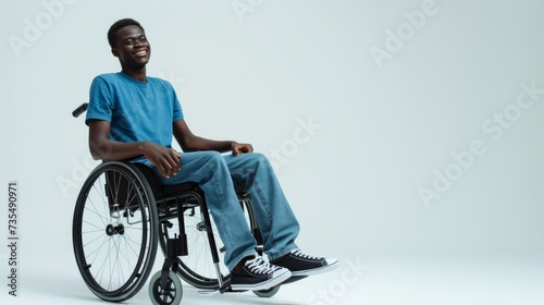 white man with a physical disability smiling and sitting in a wheelchair dressed in jeans, a blue t-shirt, positioned against a white background, Fashion mockup, Lifestyle, Stylish studio background