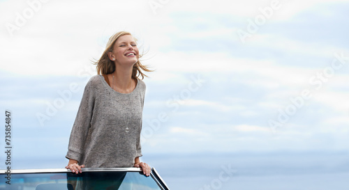 Smile, blue sky and convertible car with woman on road trip for travel, vacation or holiday in summer. Mockup, driving and journey with happy young person in vehicle for transport in fresh air