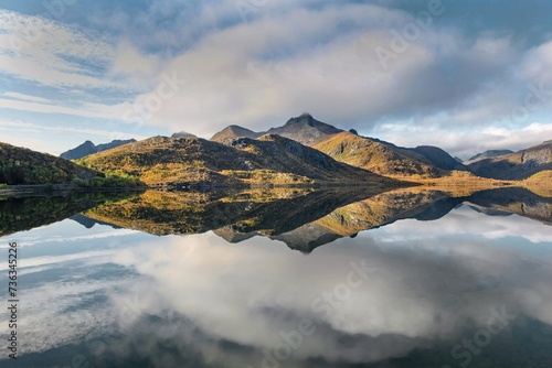 beautiful mountainous landscape in Norway reflected on the water with clouds in the sky - svolvaer in Norway