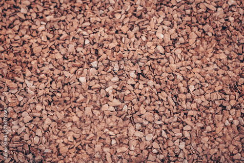 Red gravel, crushed stone, small stones, gravel texture stones background. small stones in the background. red gravel texture,