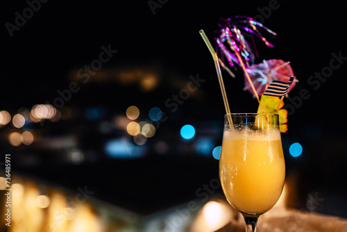 Orange cocktail against the backdrop of the night city.