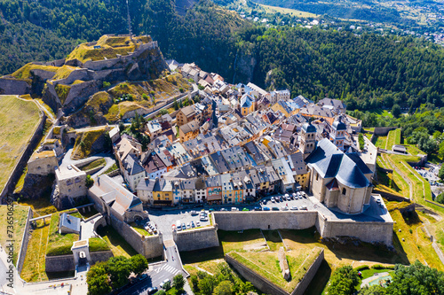 Aerial view of French fortified town of Briancon overlooking ancient fortress on hilltop and two belfries of parish church