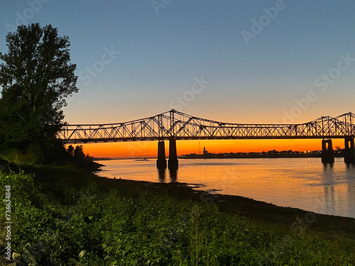 Sunset on the Mississippi River in Natchez, Mississippi with the Natchez Vidalia Bridge.