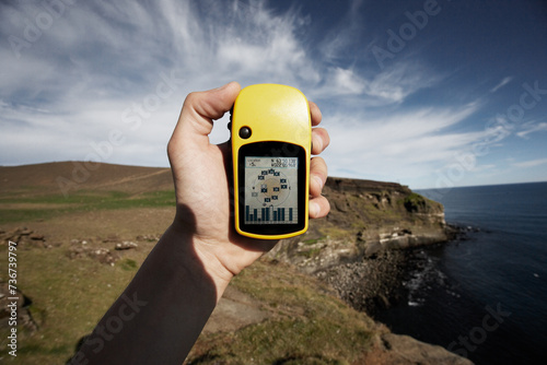 Hand Holding Yellow GPS Navigator, Reykjanes, Iceland