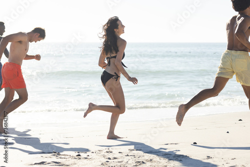 Diverse friends enjoy a lively run on the beach